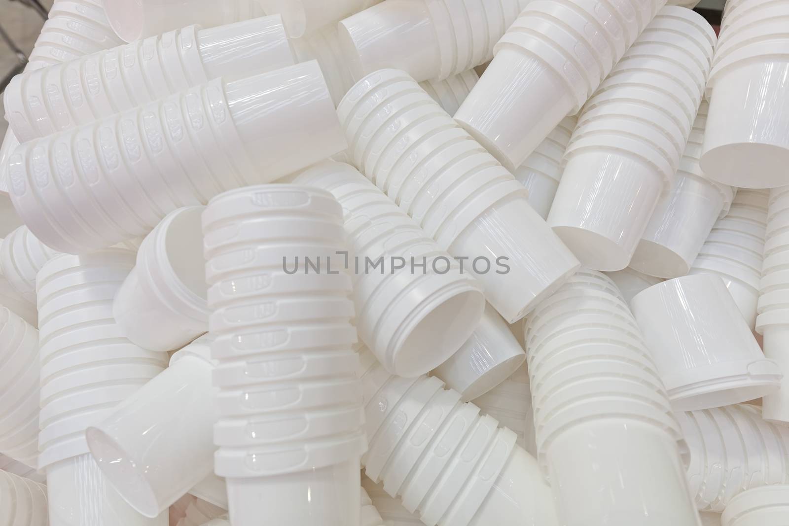 products from machinery for the production of plastic cups, note shallow depth of field