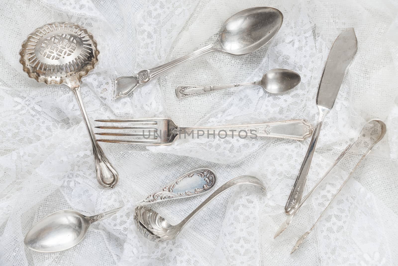 Silverware on a white guipure fabric closeup