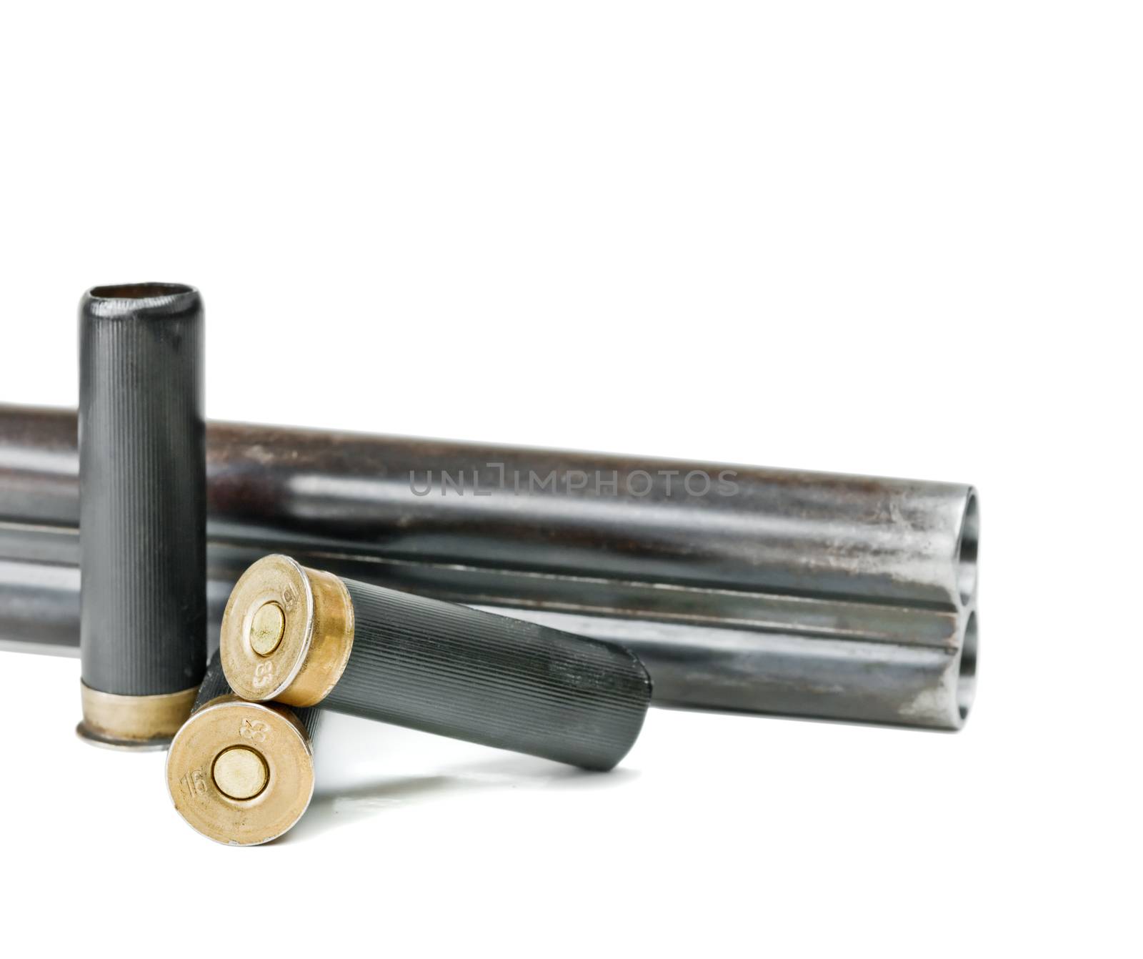 Hunting shotgun barrels and three black cartridges isolated on a white background