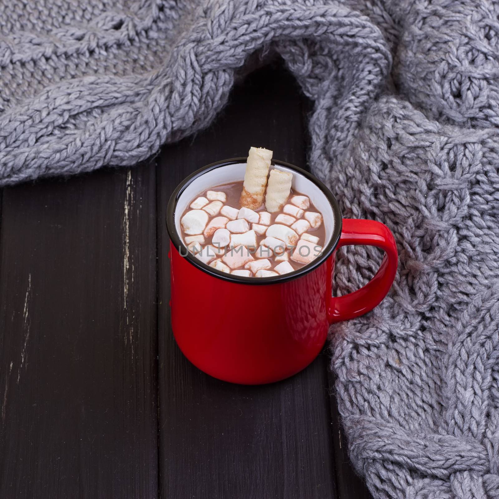 Hot cocoa with marshmallows with spices on the old wooden boards. Coffee, cocoa, cinnamon, nuts, cozy sweater. Autumn Still Life