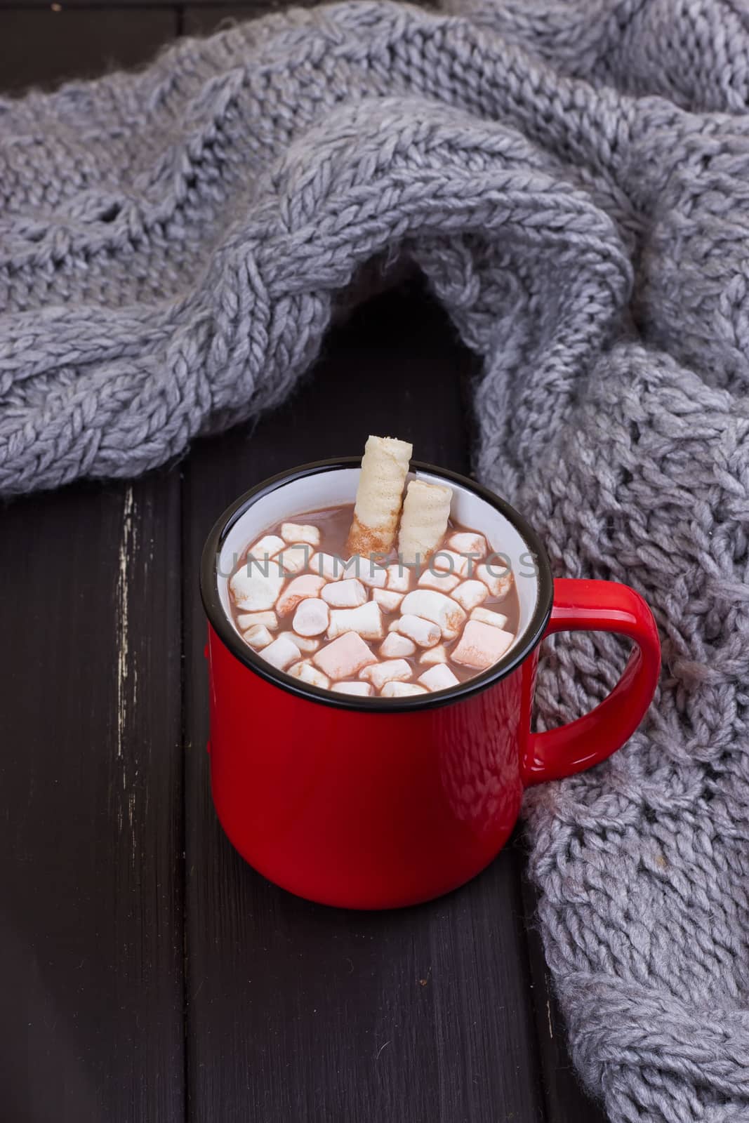 Hot cocoa with marshmallows with spices on the old wooden boards. Coffee, cocoa, cinnamon, nuts, cozy sweater. Autumn Still Life