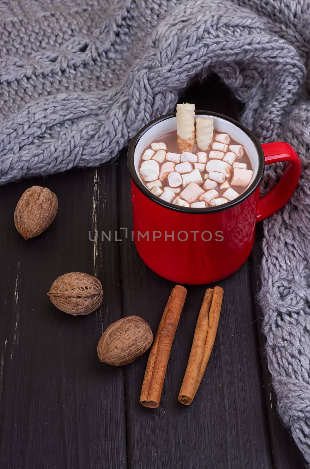 Hot cocoa with marshmallows with spices on the old wooden boards. Coffee, cocoa, cinnamon, nuts, cozy sweater. Autumn Still Life