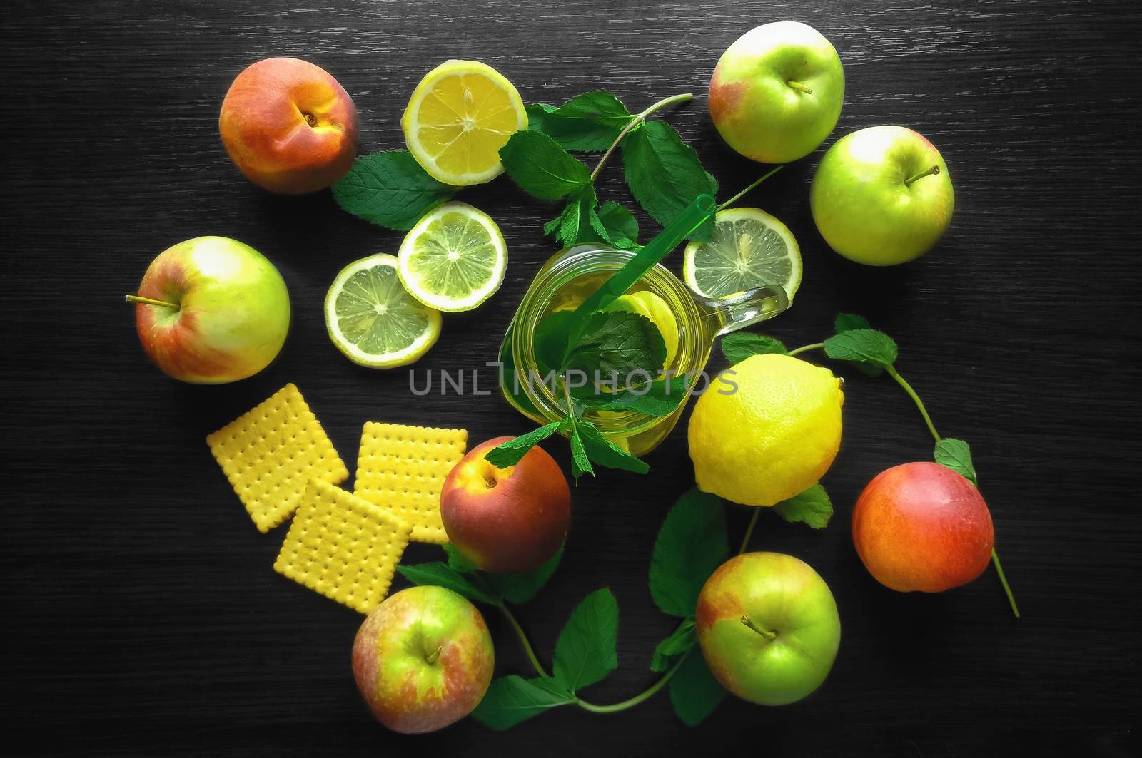 Natural fresh tea in a cup on wooden table with lemon and apples. Concept for eco lifestyle. Healthy food theme
