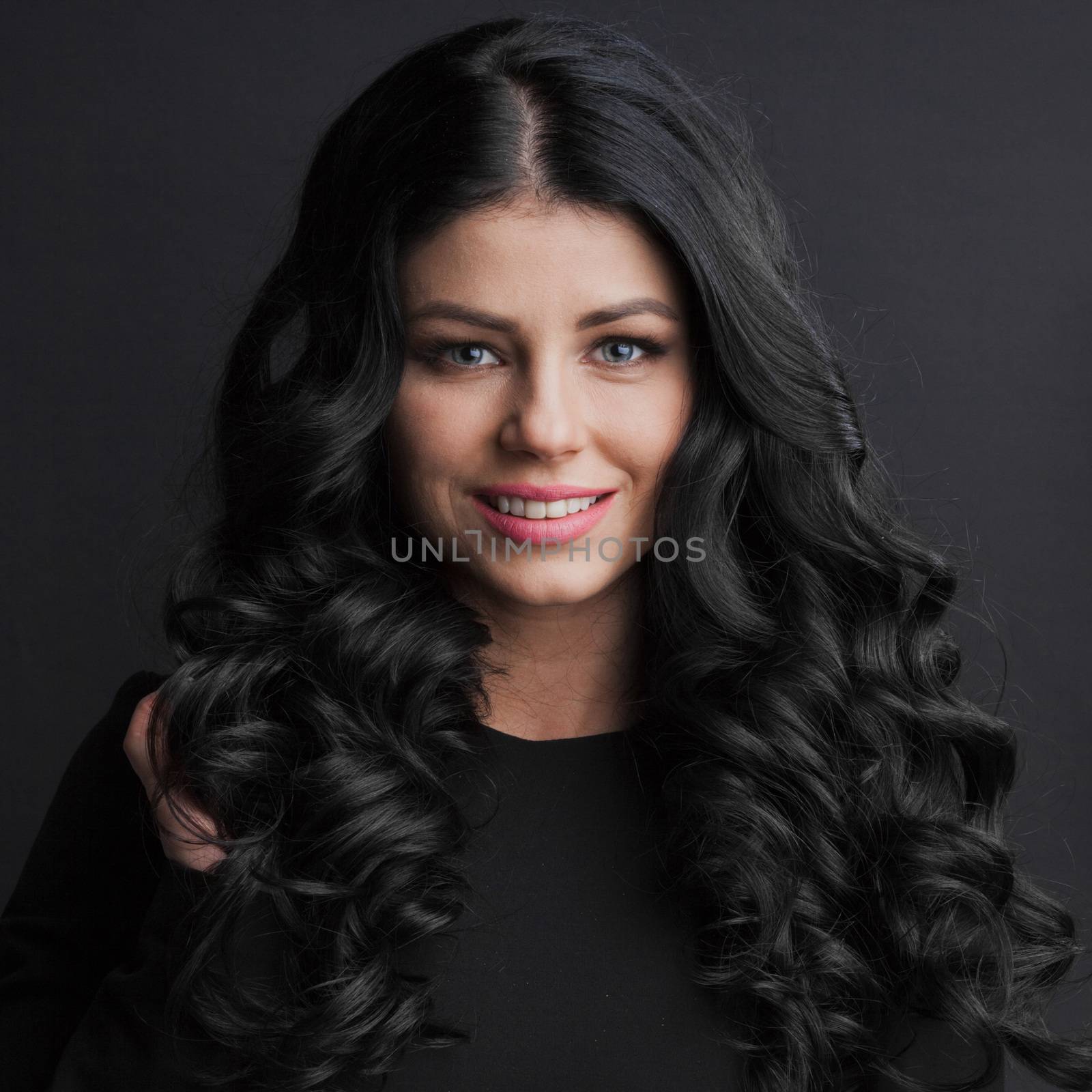 Portrait of gorgeous brunette with curly long hair