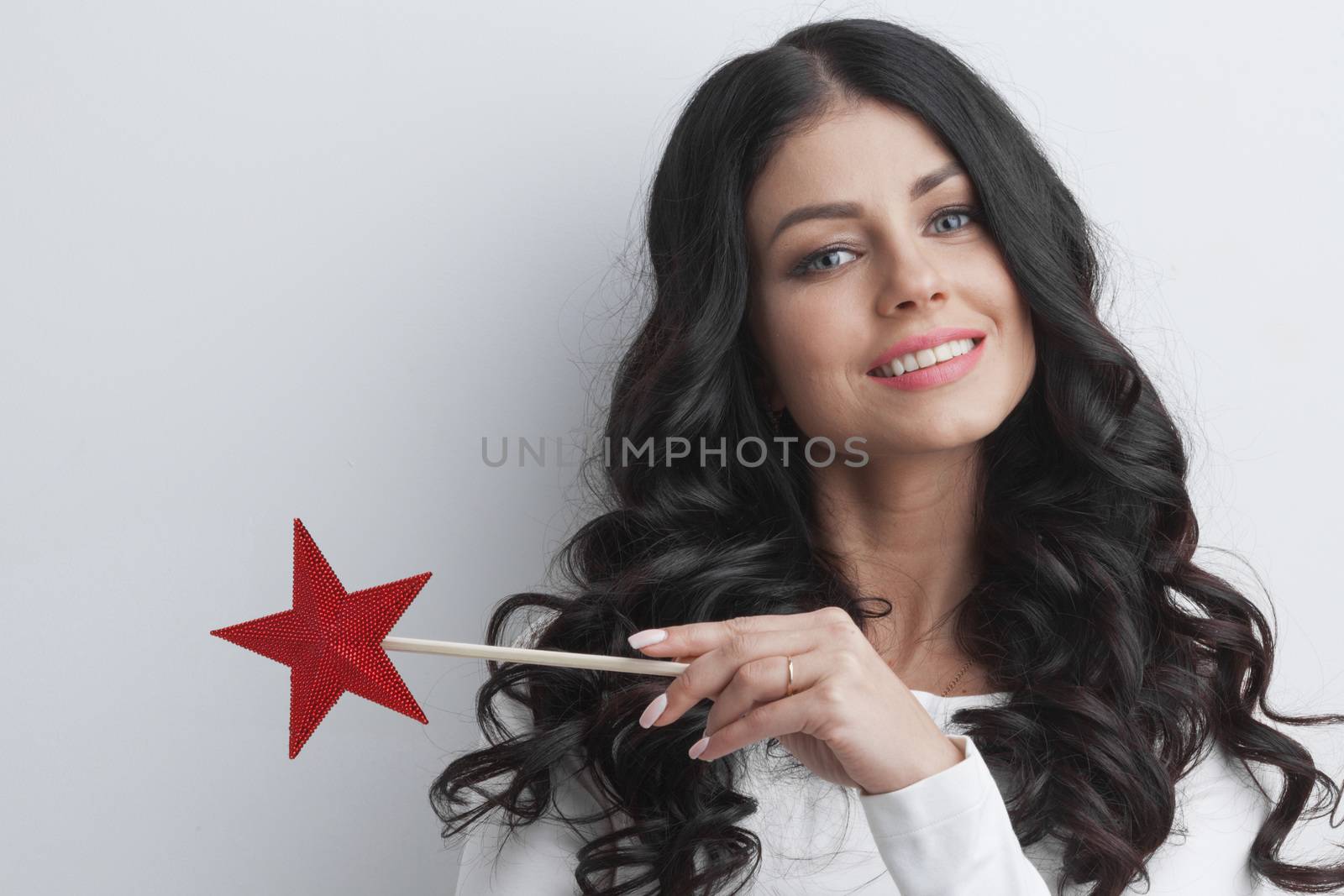 Gorgeous woman magician with star shaped magic wand