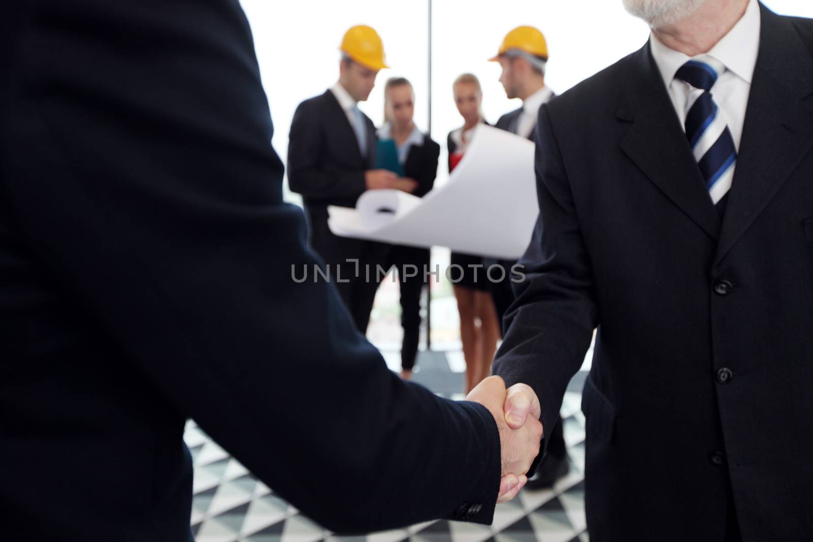 Business meeting of architects and investors shaking hands in office