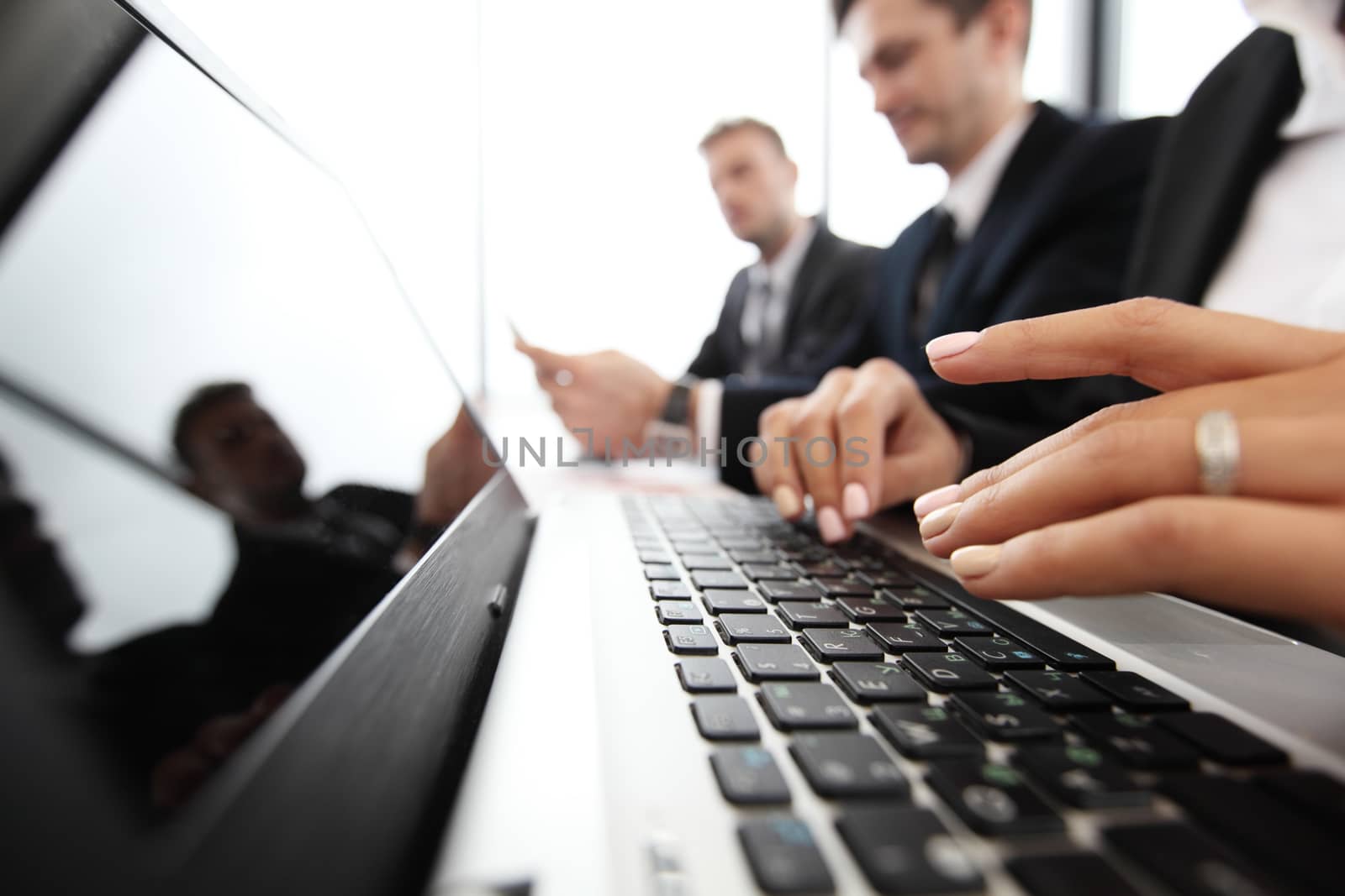 Mixed group of people in business meeting working with documents and computers