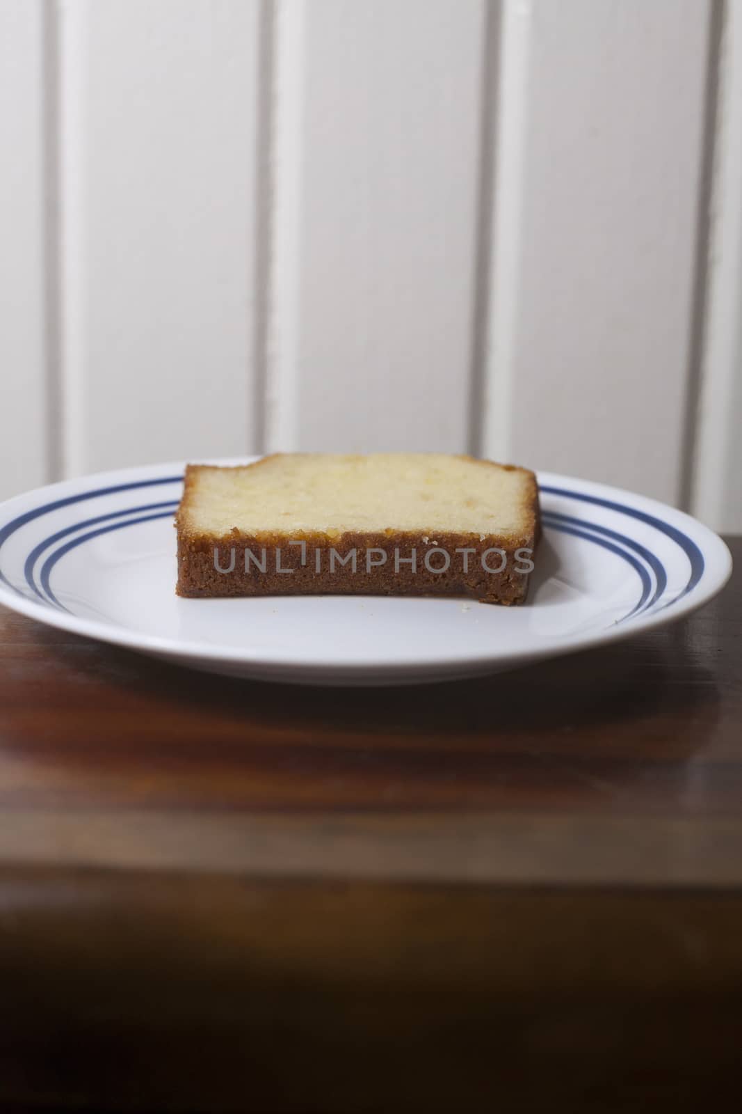 A single slice of pound cake on a small plate