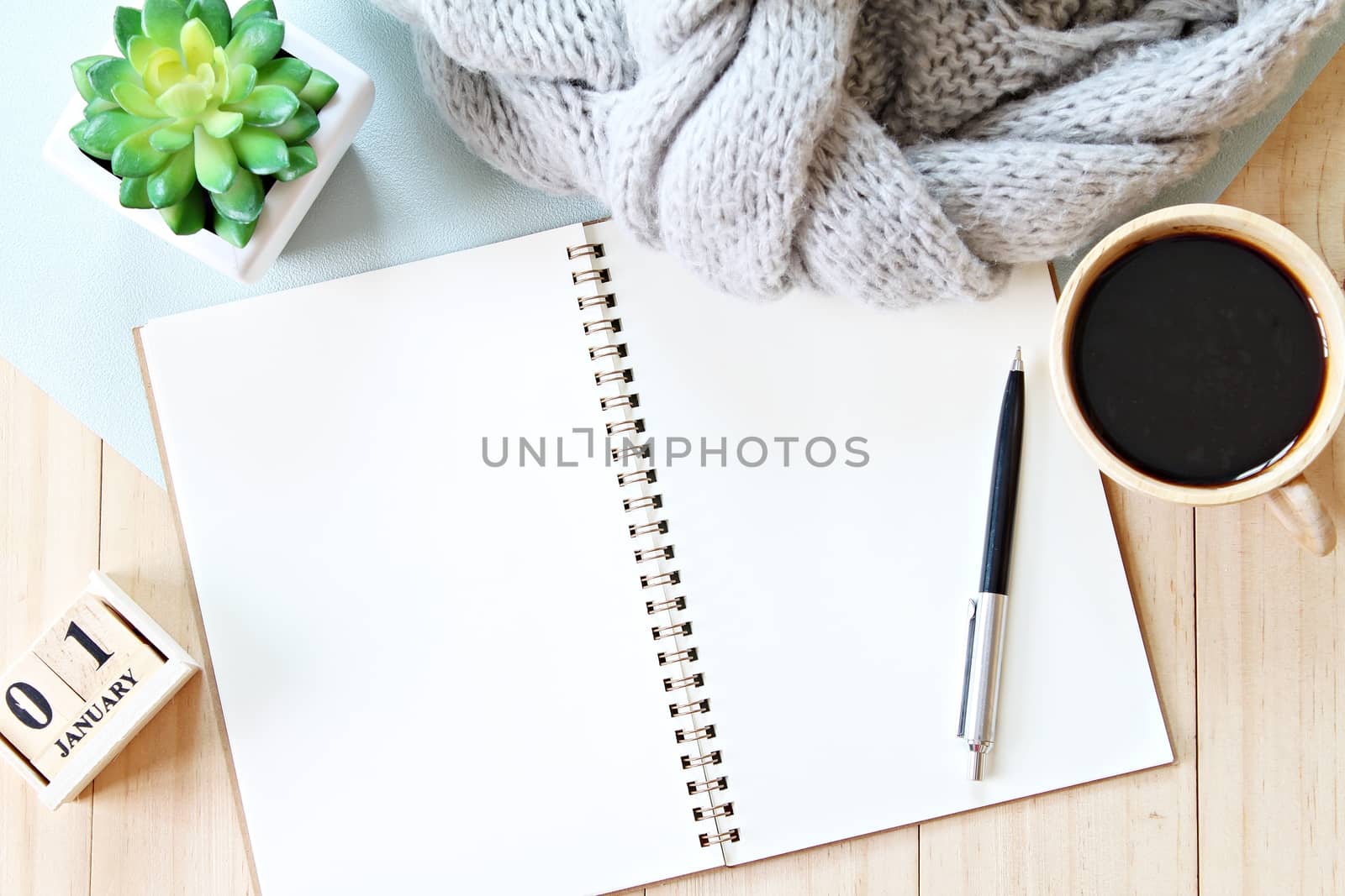 Business, holiday or new year planning concept : Desk table with scarf, notebook paper, cube calendar and coffee cup, Top view or flat lay with copy space ready for adding or mock up