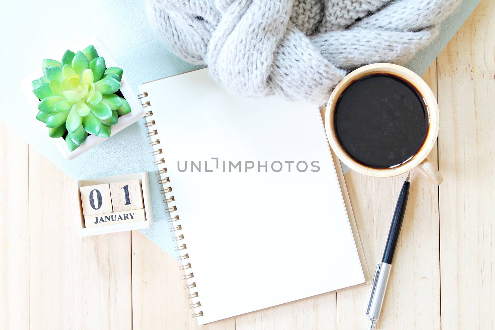 Business, holiday or new year planning concept : Desk table with scarf, notebook paper, accessories, cube calendar and coffee cup, Top view or flat lay with copy space ready for adding or mock up