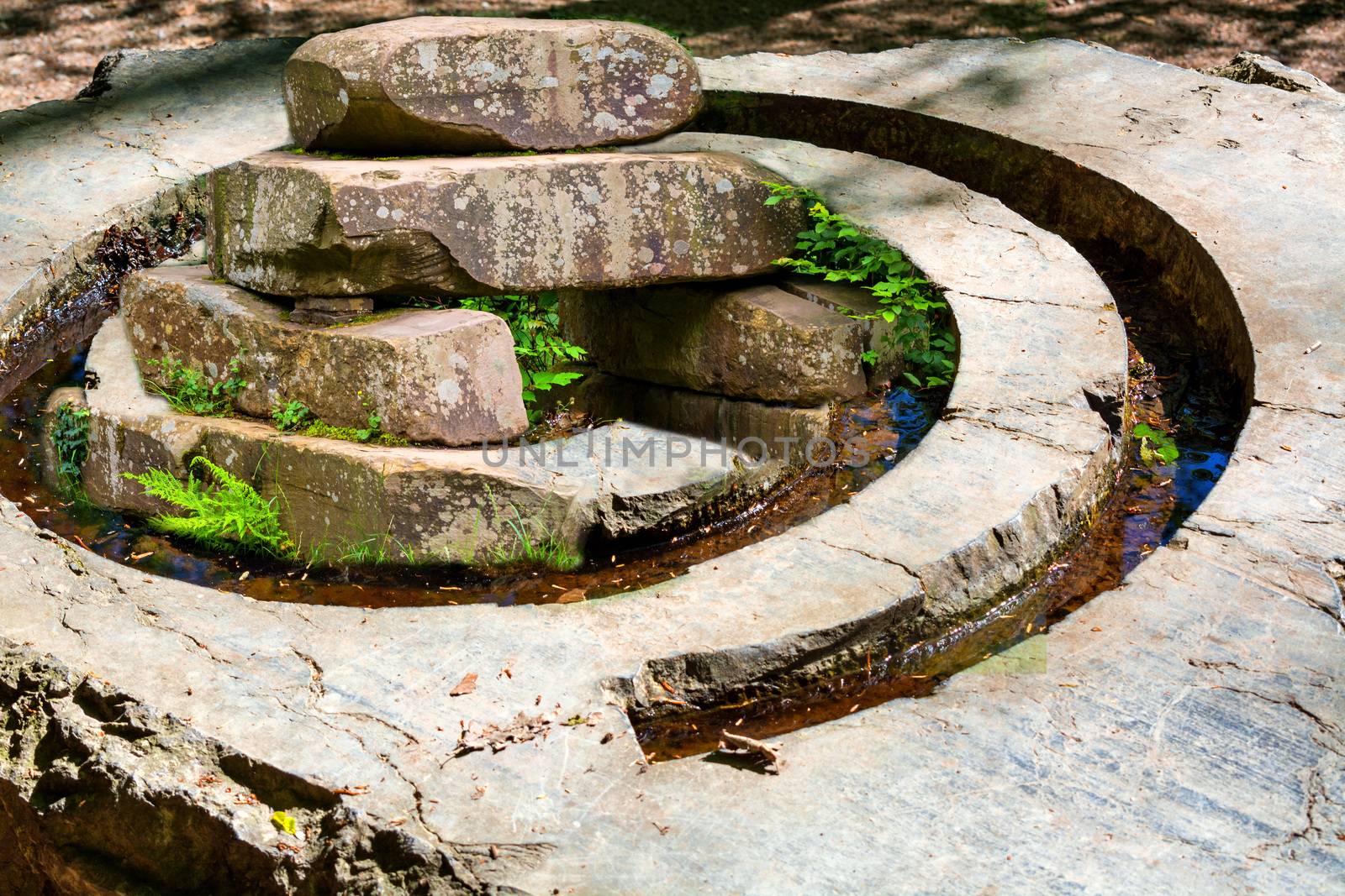 Stone pile from the Stone Age similar to a giant stone with stone spiral symbol for energy and growth.