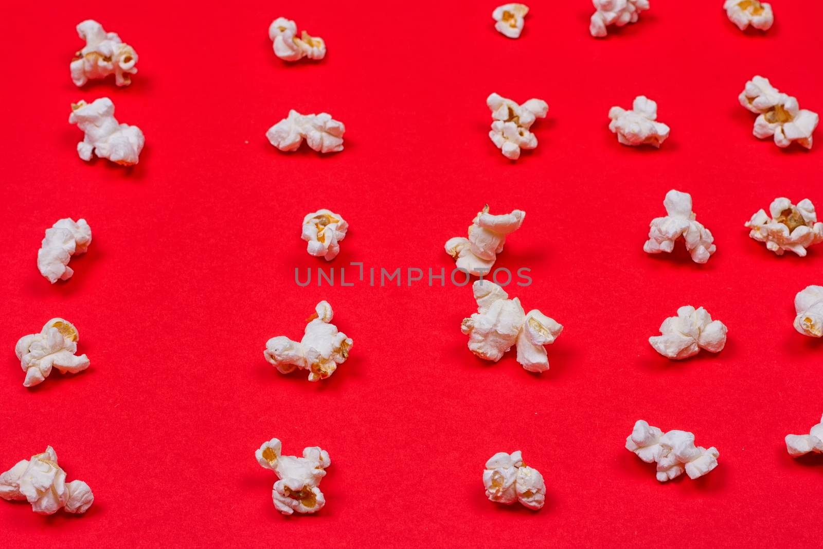 popcorn neatly laid out on a red background