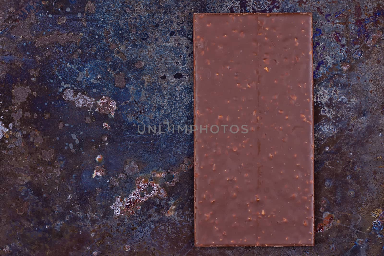 Milk chocolate bar on a black grunge background