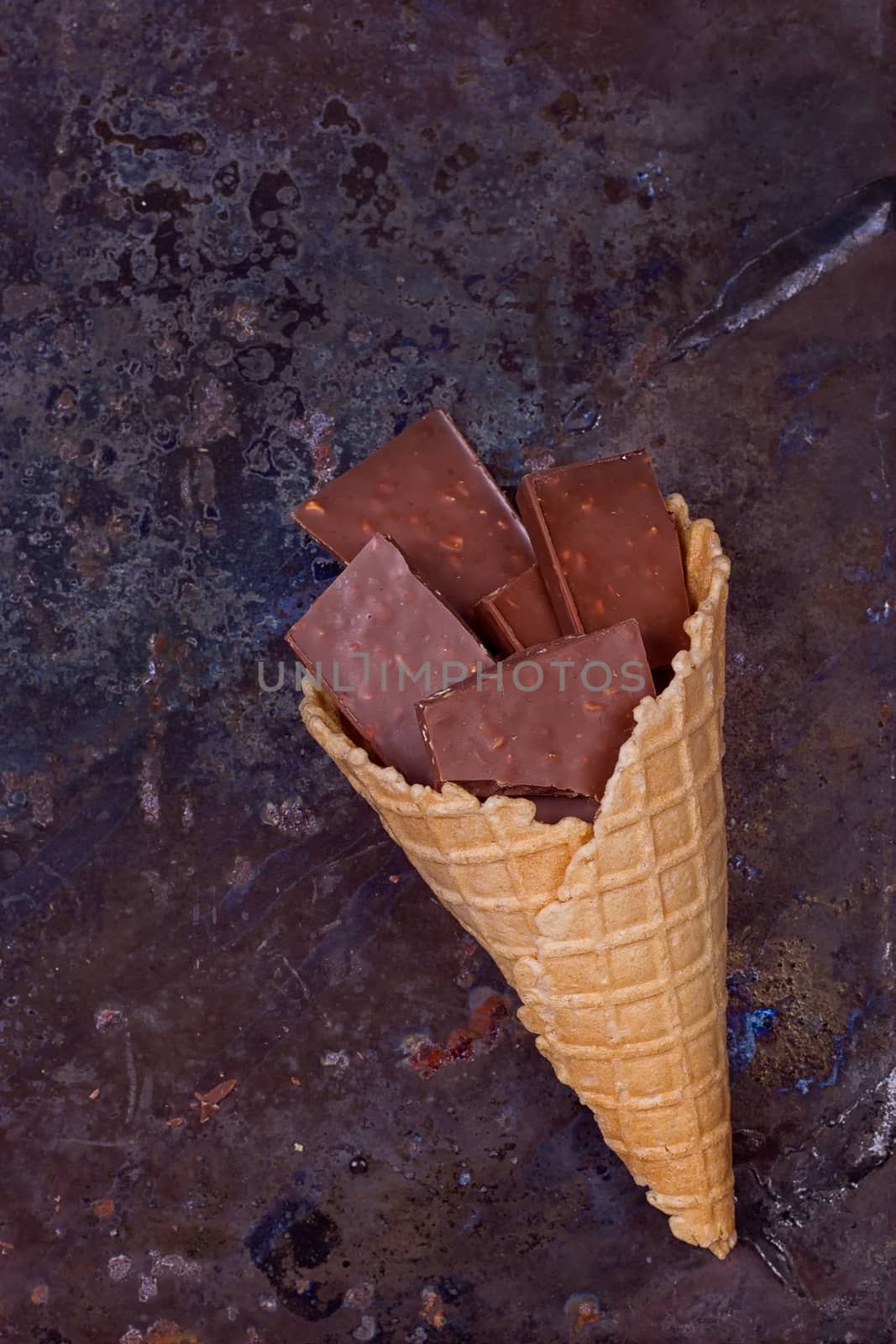 Chocolate in waffle cone chocolate concept on a grunge background