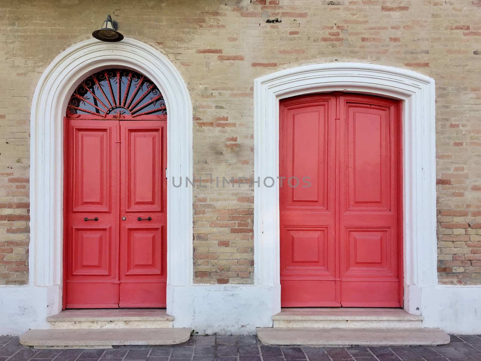 Vintage red doors of a bricked house in Italy