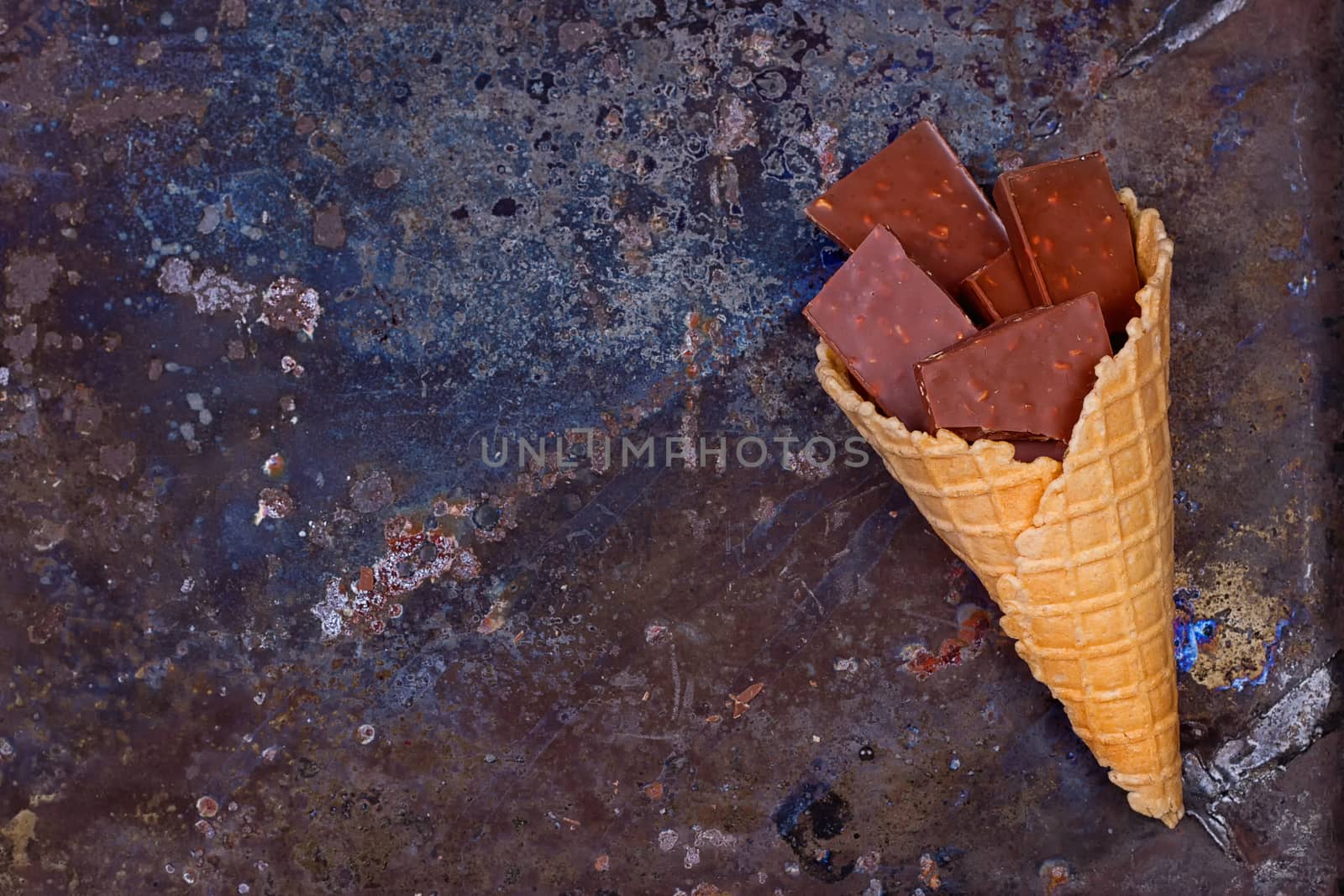 Chocolate in waffle cone chocolate concept on a grunge background