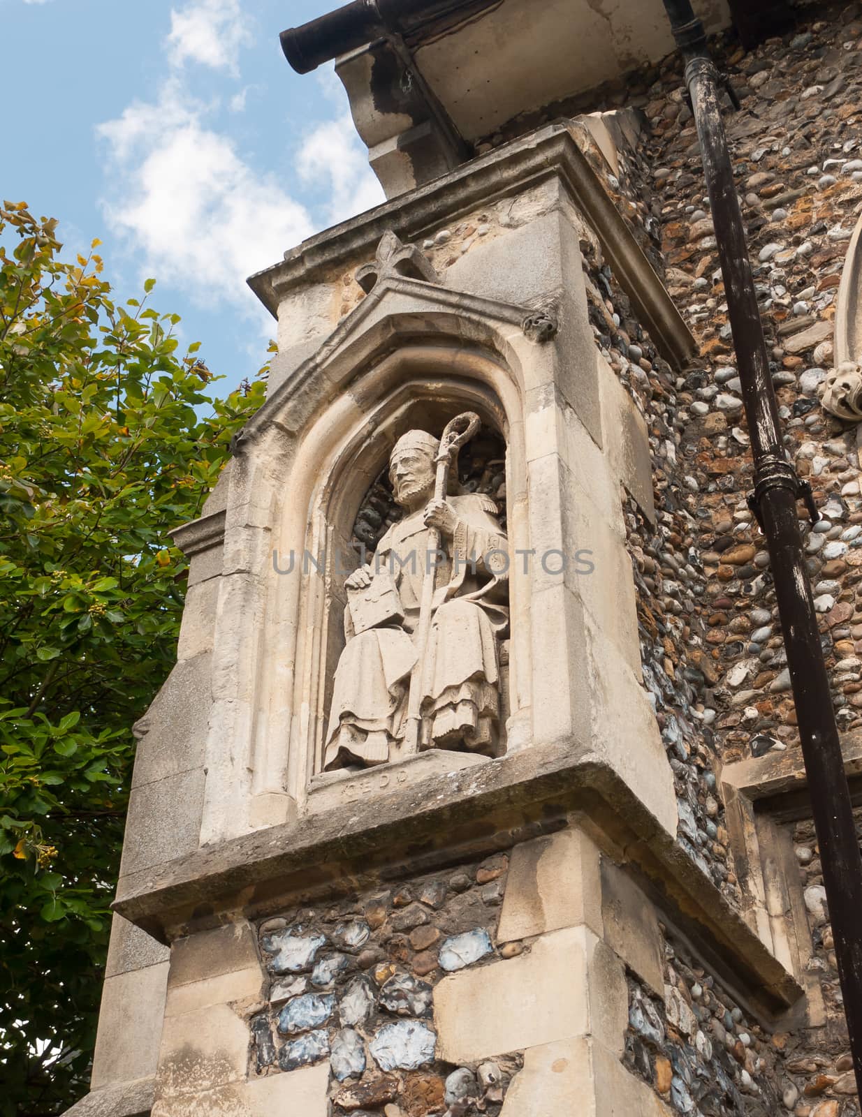 statue of priest on the outside of english christian church made of stone;Essex; England; UK