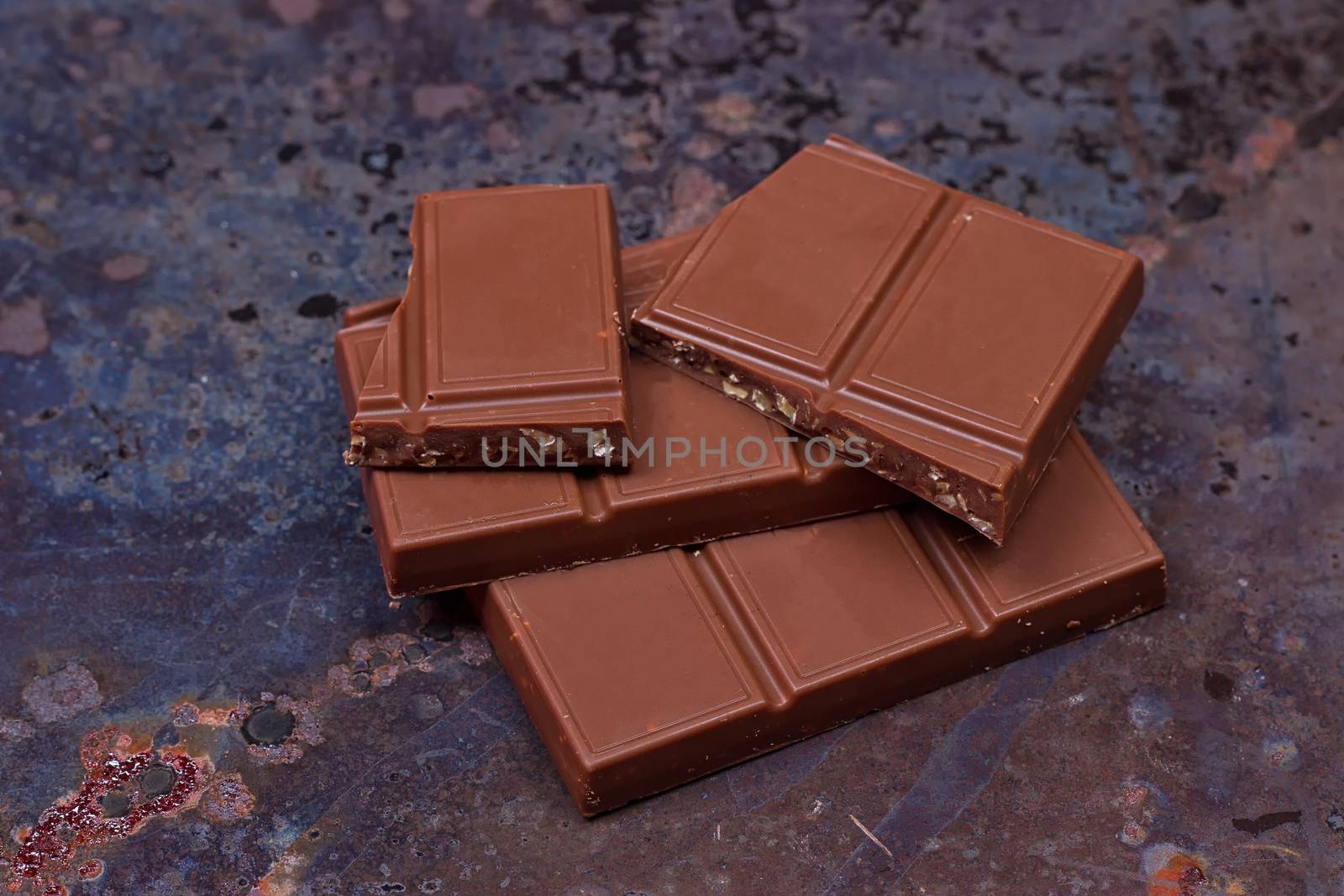 Milk chocolate bar on a black grunge background