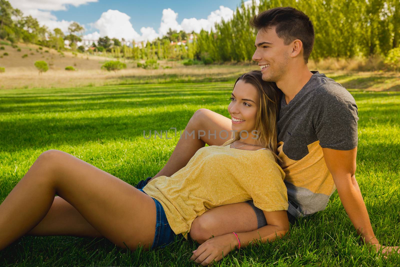 Young couple sitting on the grass and relaxing