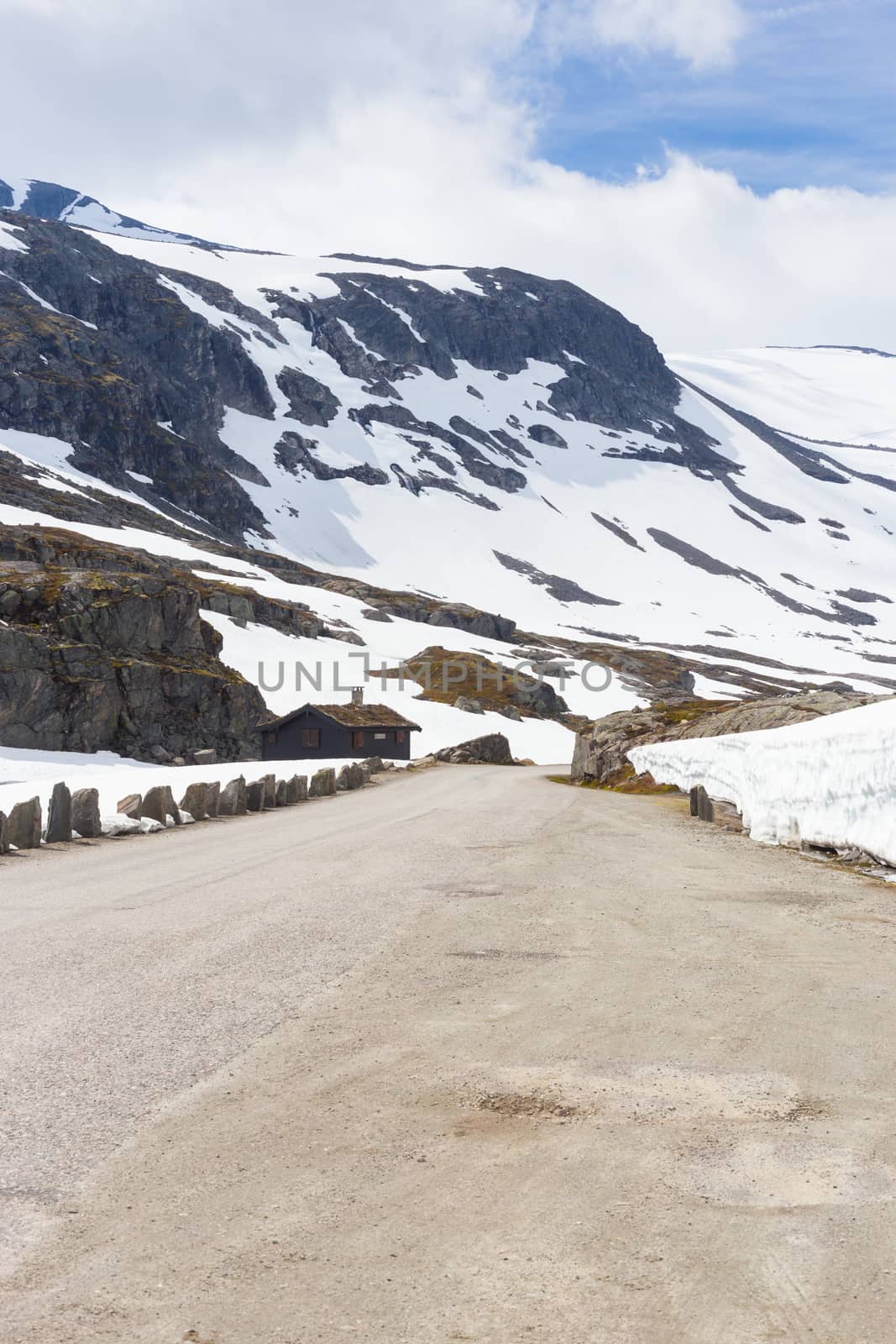 Road, house and mountain with snow in summer, Norway