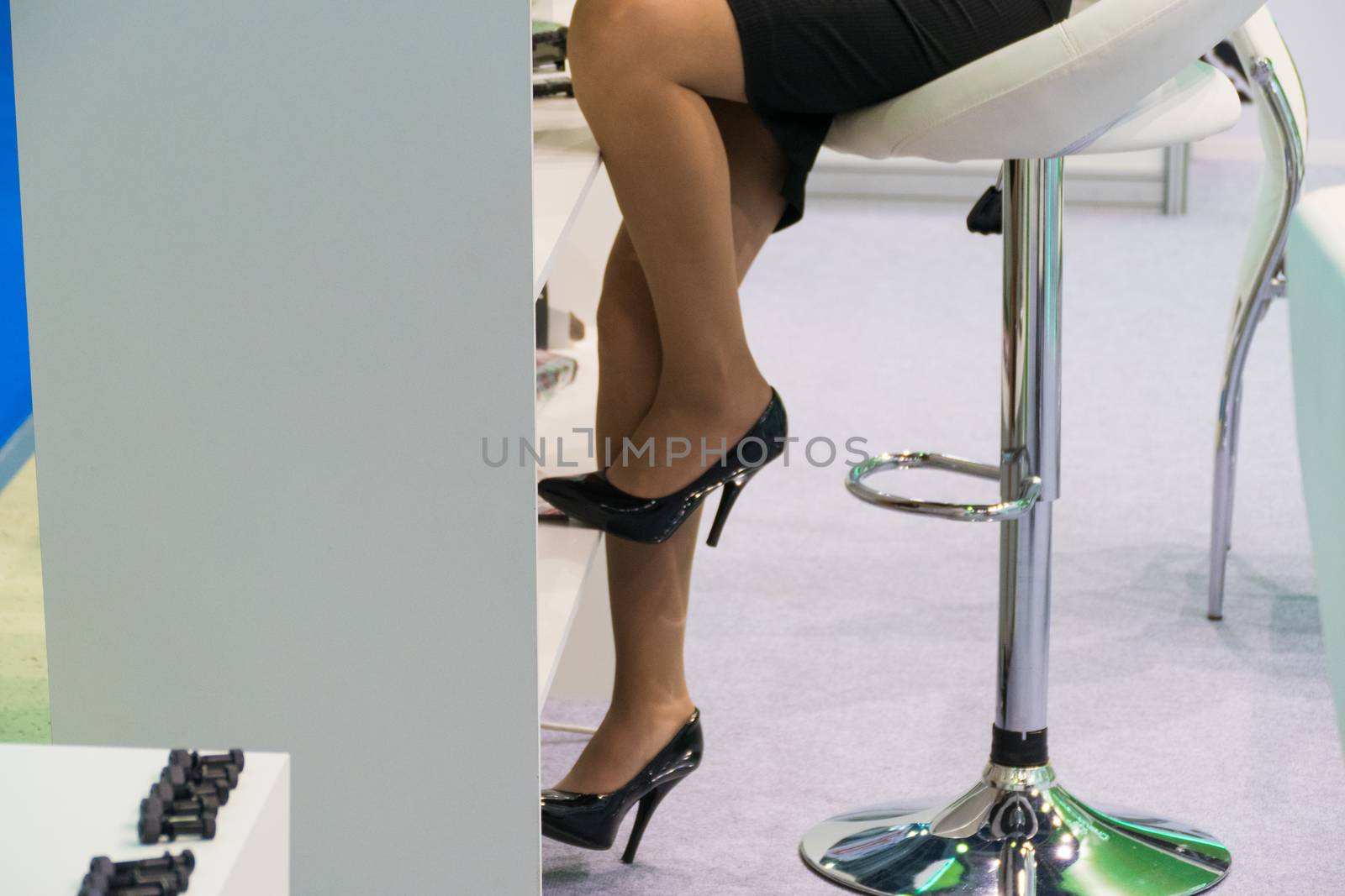 Female feet in short skirt, on stiletto heels, in the office