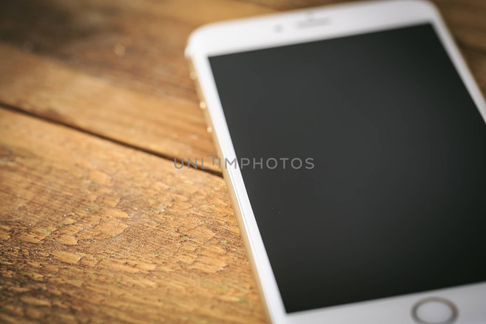 Smart phone on the wooden table