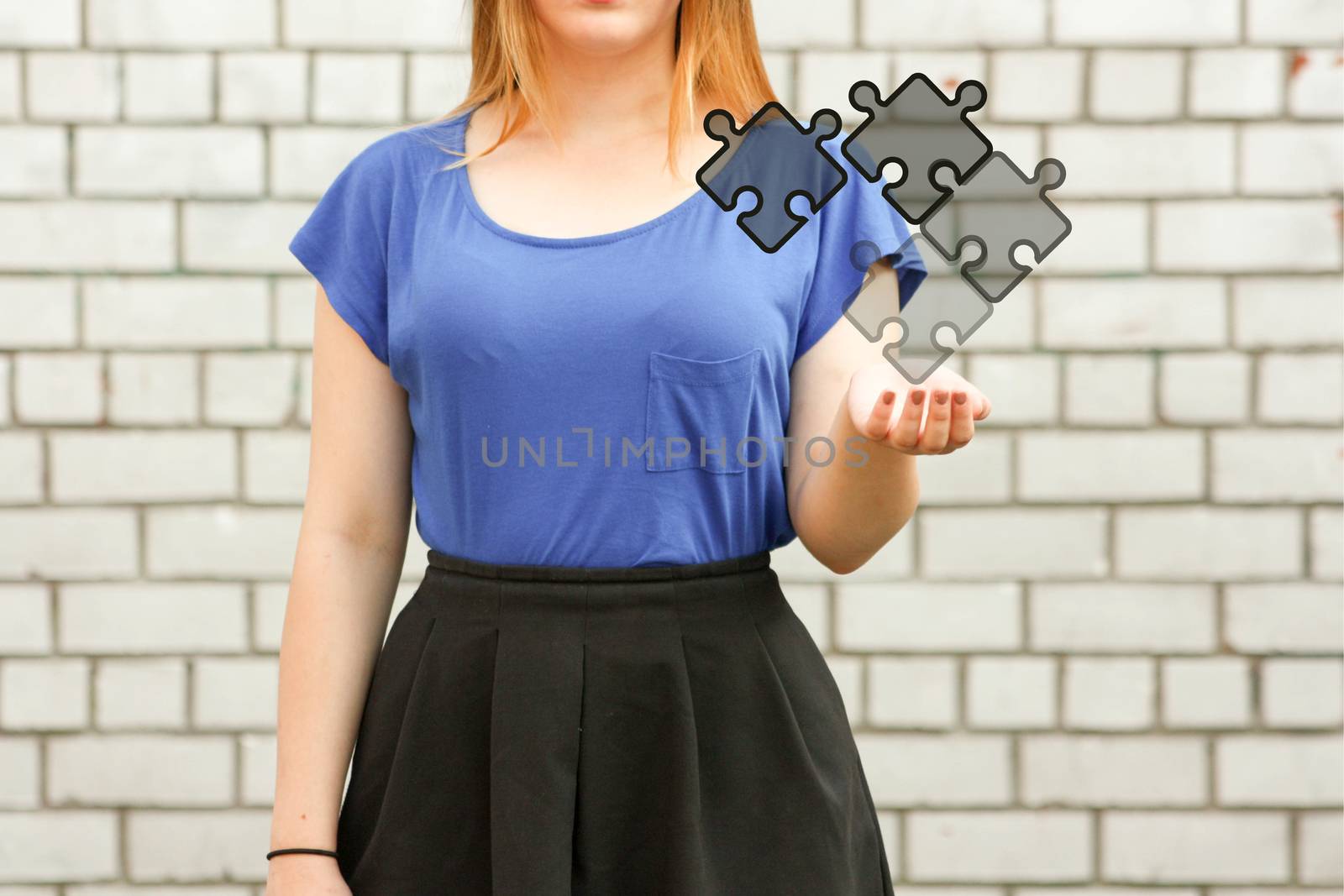 system concept puzzle collect. photo for your design. girl in blue near a white brick wall