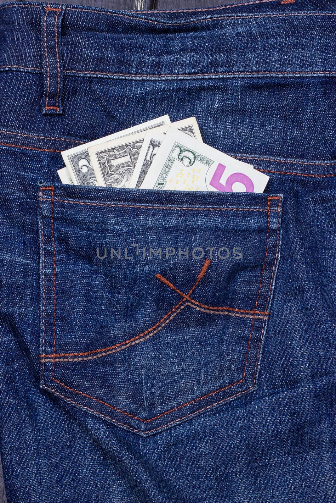 dollars in a pocket of jeans by victosha