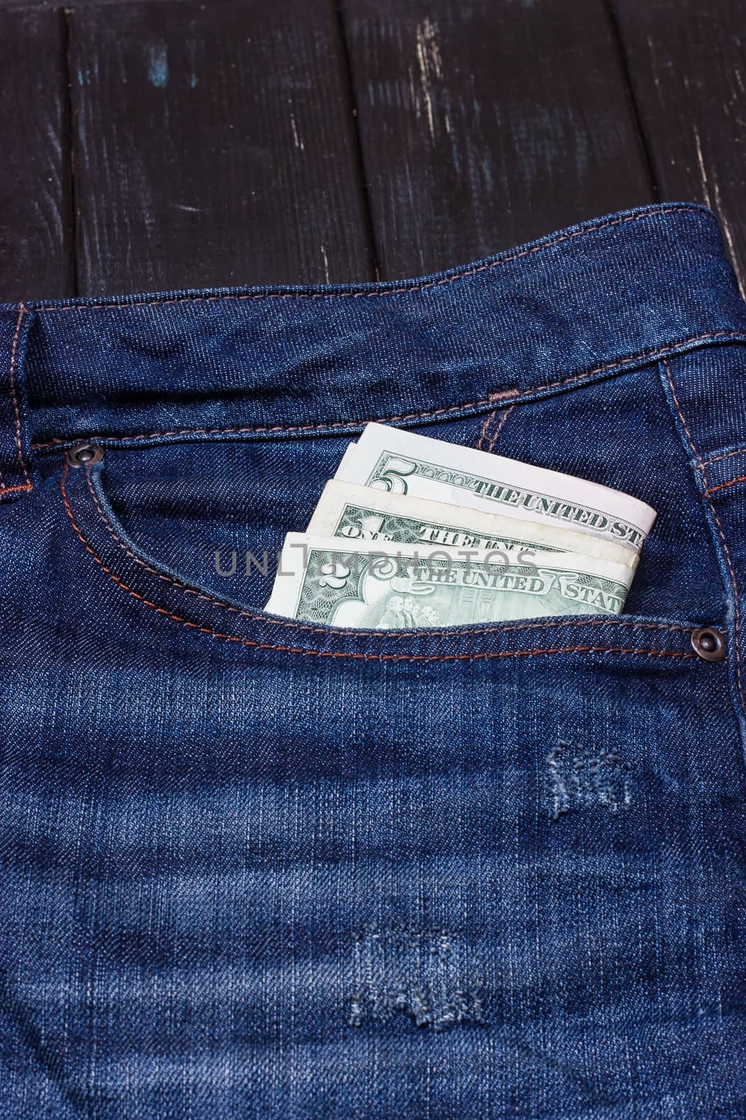 dollars in a pocket of jeans by victosha