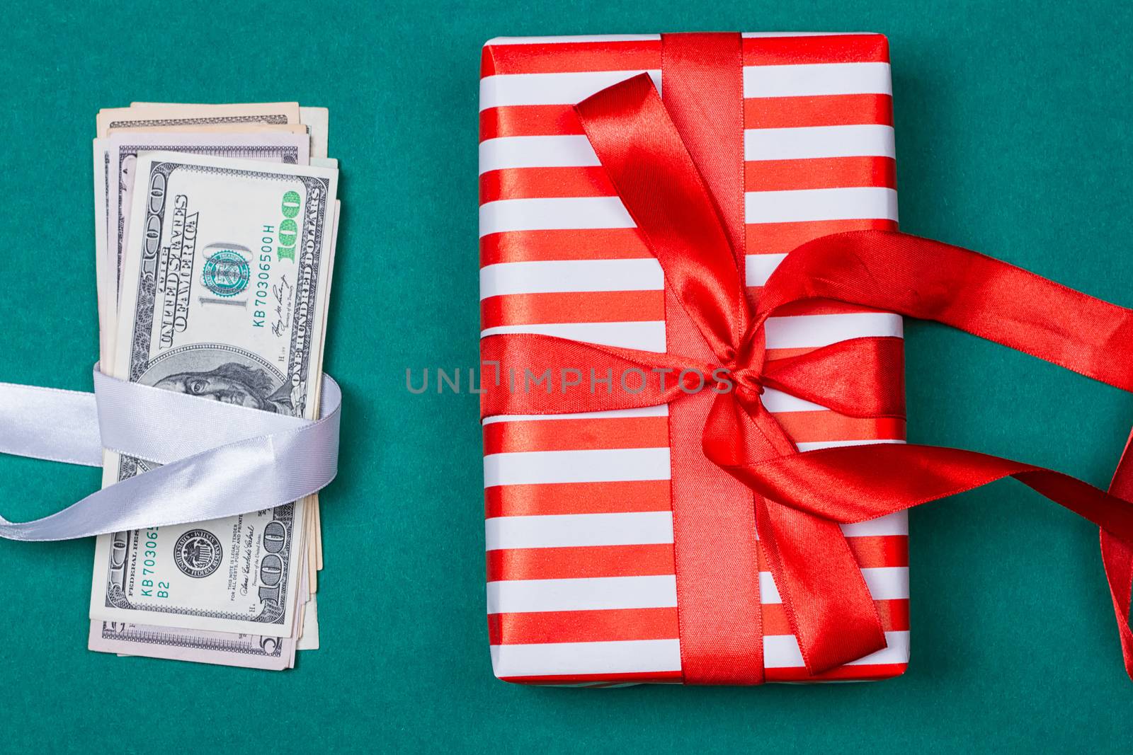 Concept: a gift or money. american money with gift box on a green background