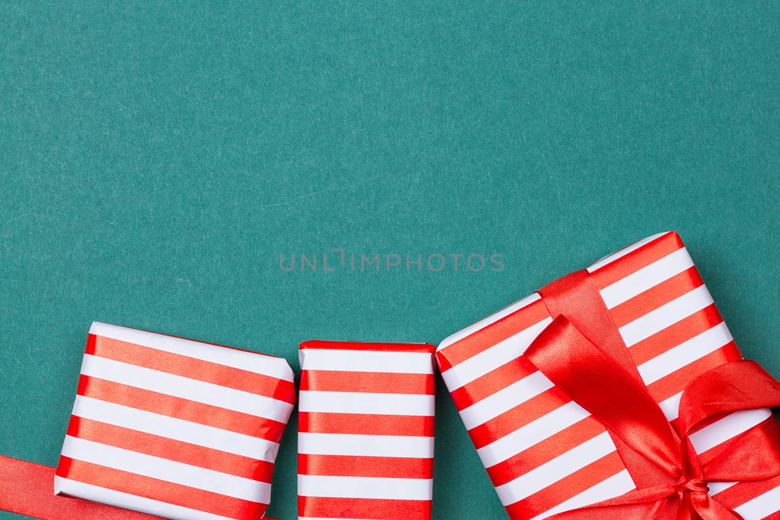 Christmas gift boxes on green background. Top view with copy space