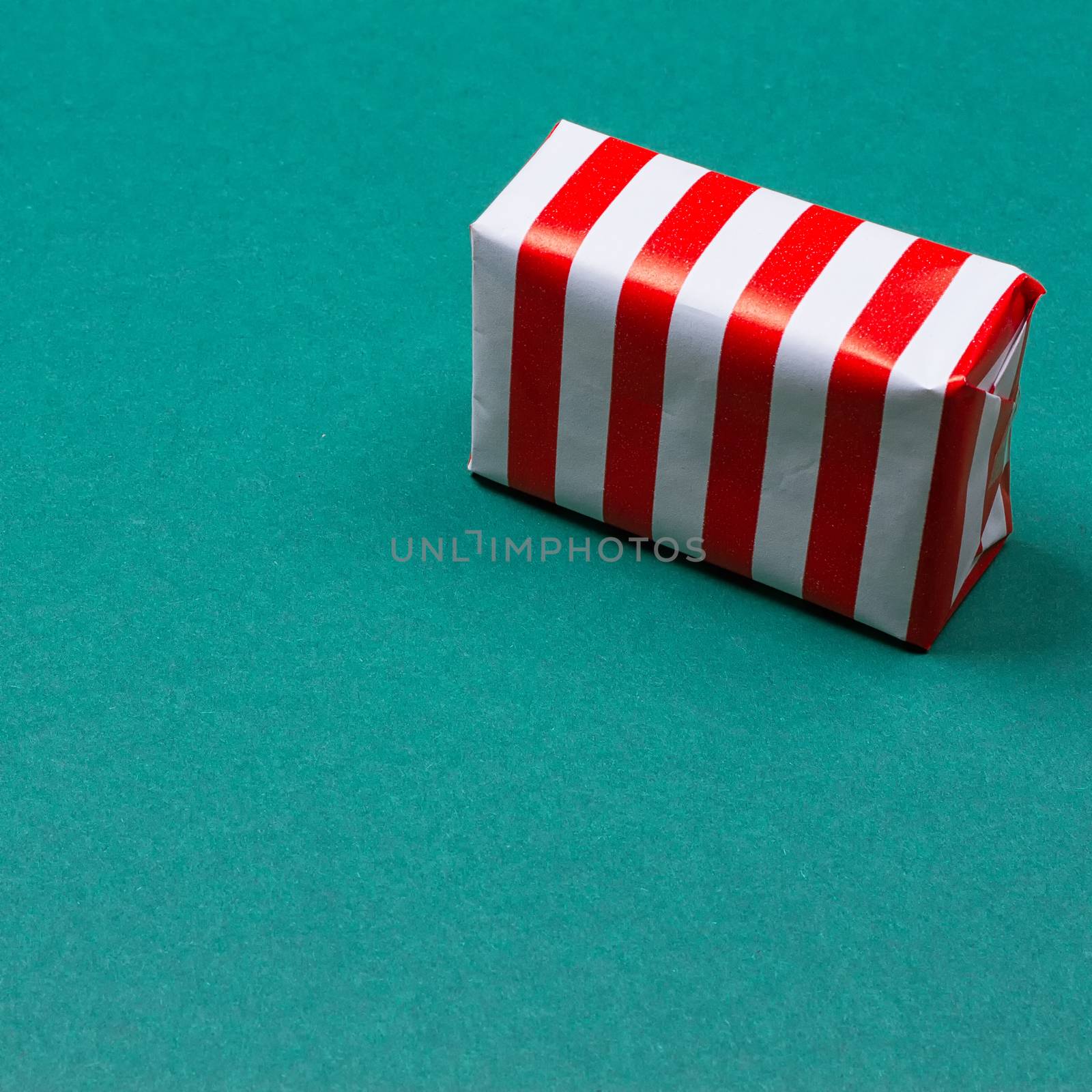 Christmas gift box on green background. Top view with copy space