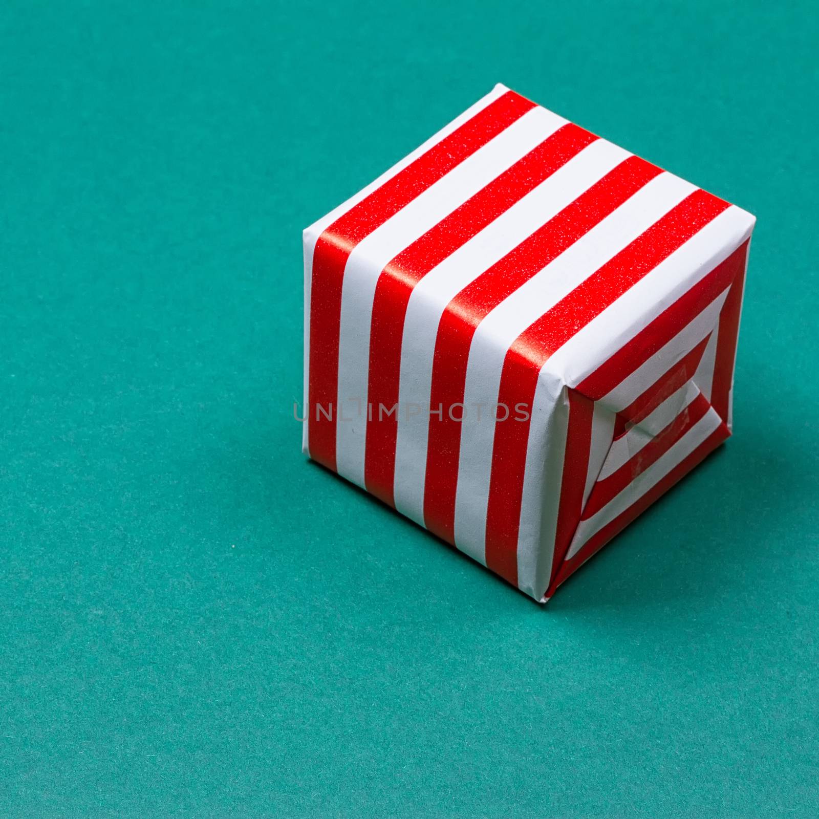 Christmas gift box on green background. Top view with copy space