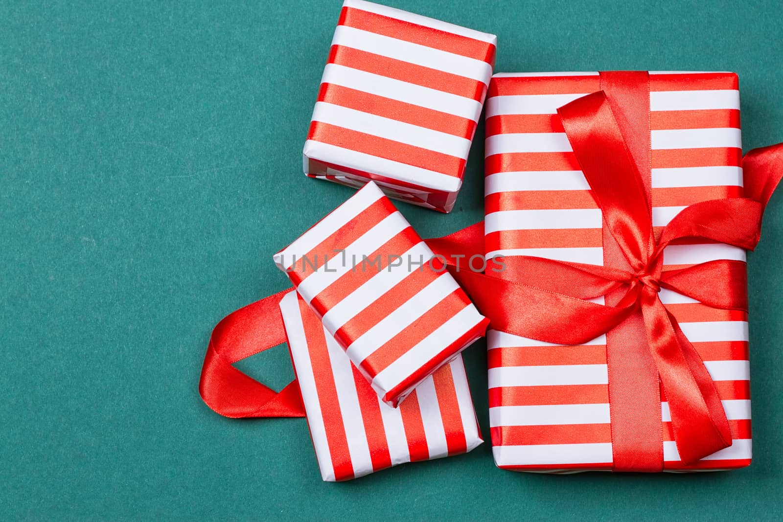 Christmas gift boxes on green background. Top view with copy space