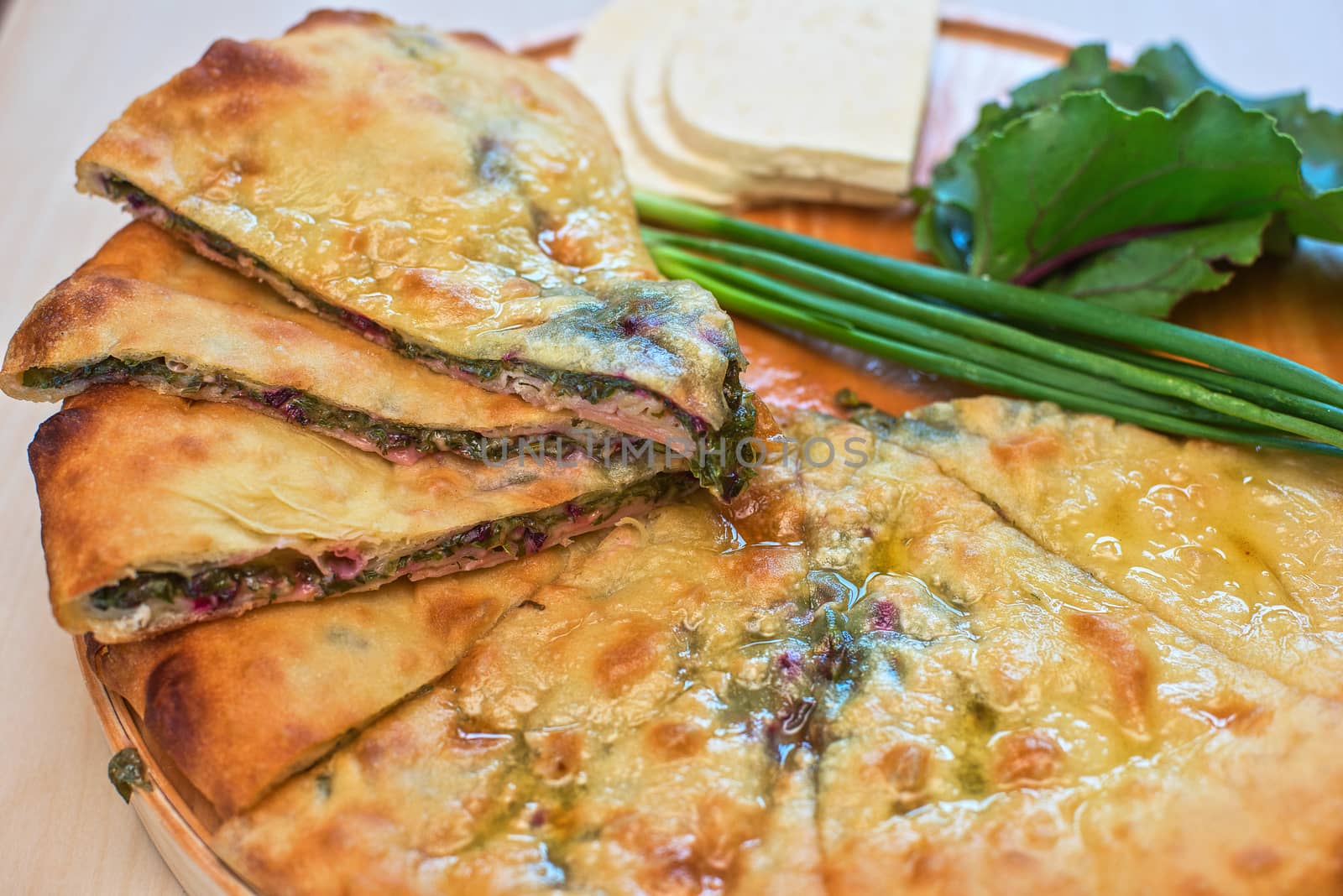 ossetian pie with beetroot onion and cheese on a white background