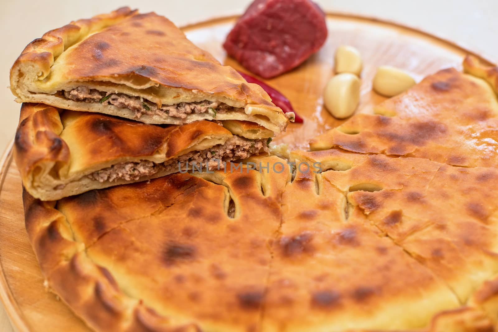 Meat ossetian pie on a white background