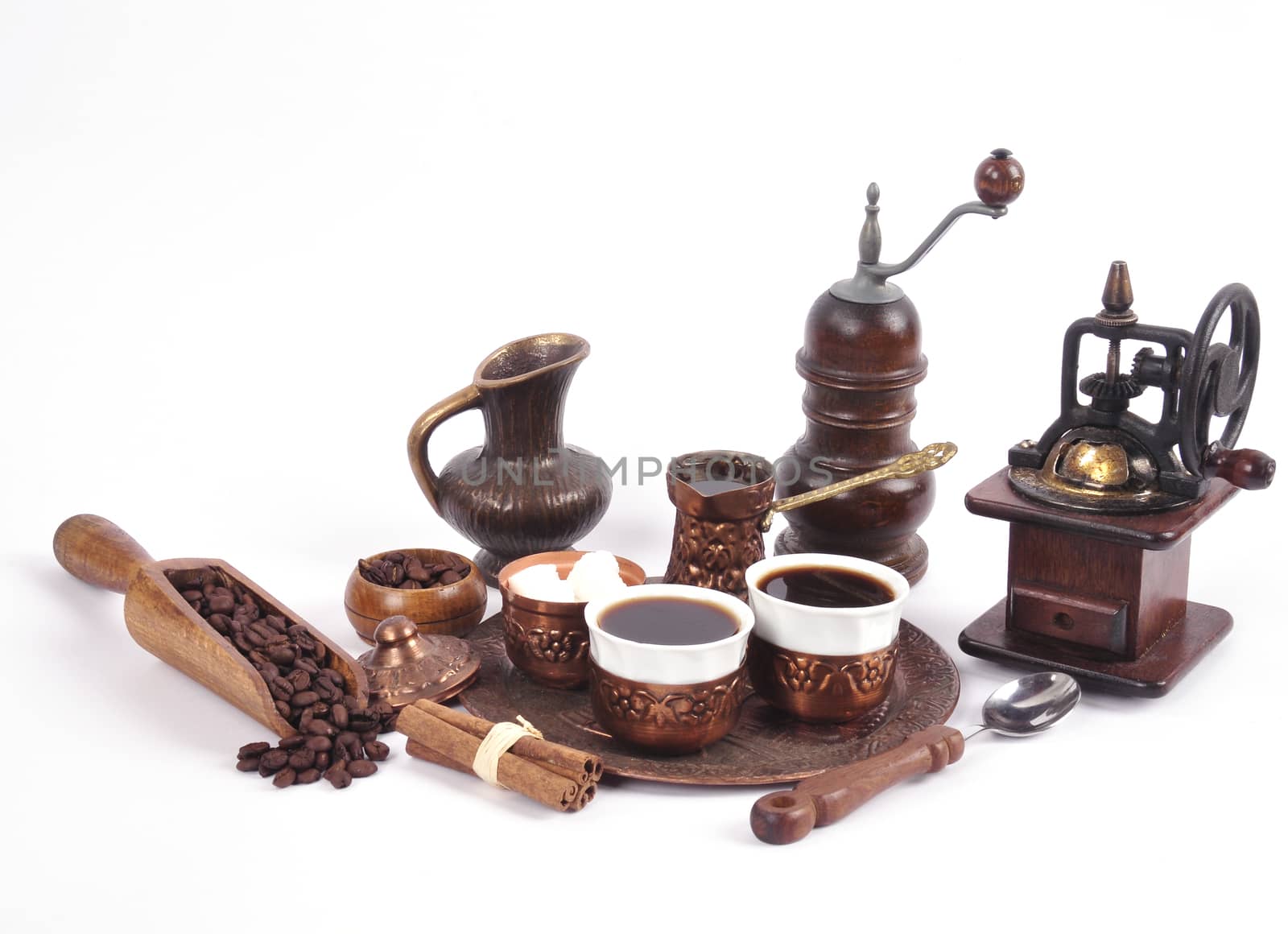 Coffee in copper coasters with accessories for coffee-drinking on a white background