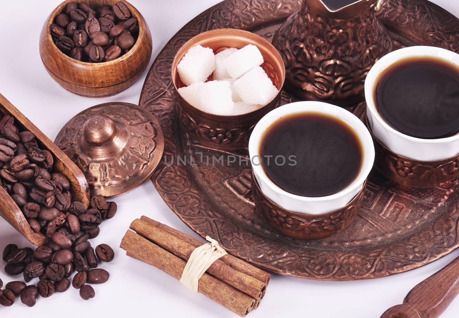 Coffee in copper coasters with accessories for coffee-drinking on a white background