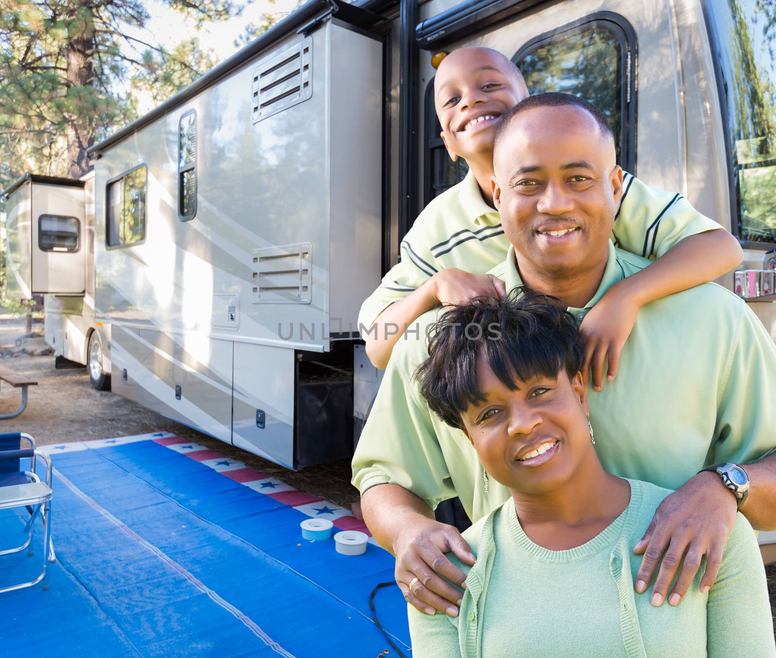 Happy African American Family In Front of Their Beautiful RV At The Campground. by Feverpitched