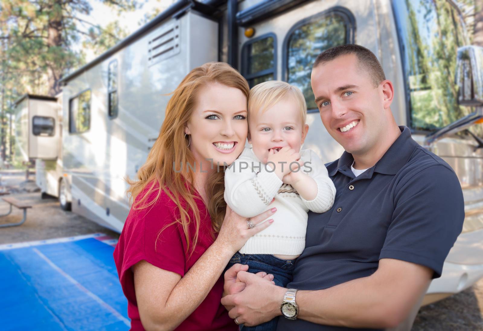 Happy Young Military Family In Front of Their Beautiful RV At The Campground. by Feverpitched