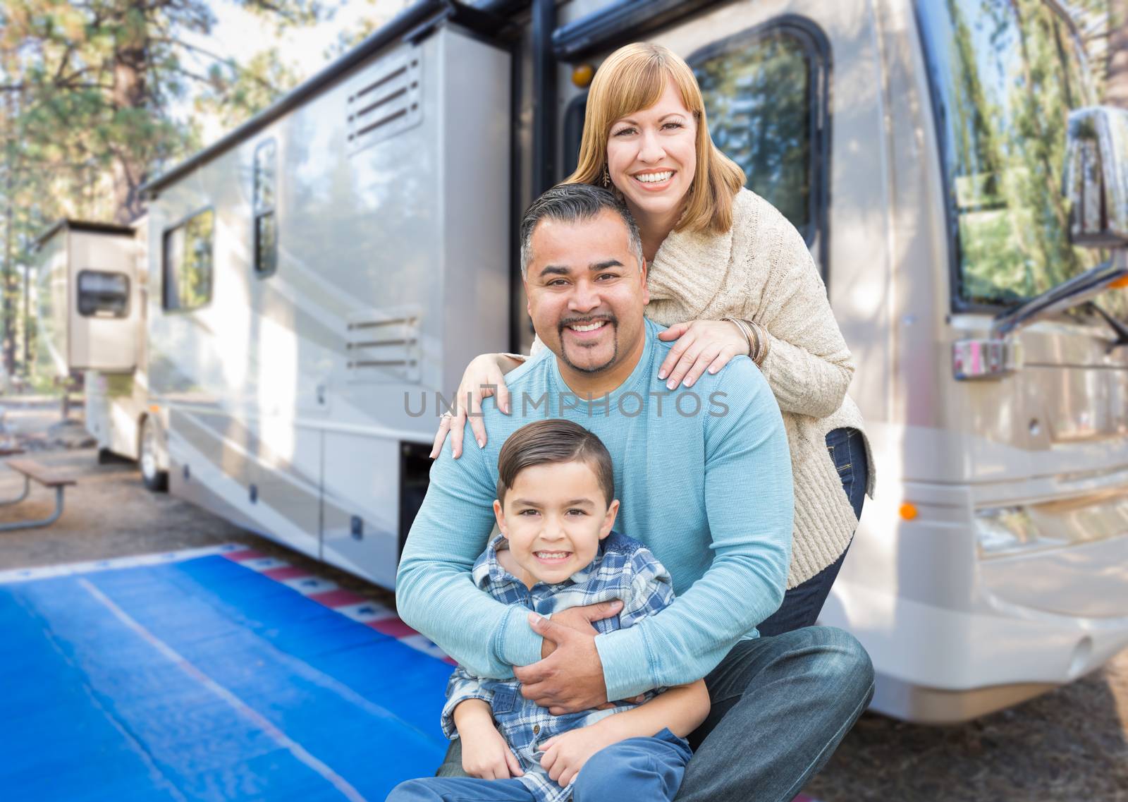 Happy Young Mixed Race Family In Front of Their Beautiful RV At The Campground. by Feverpitched