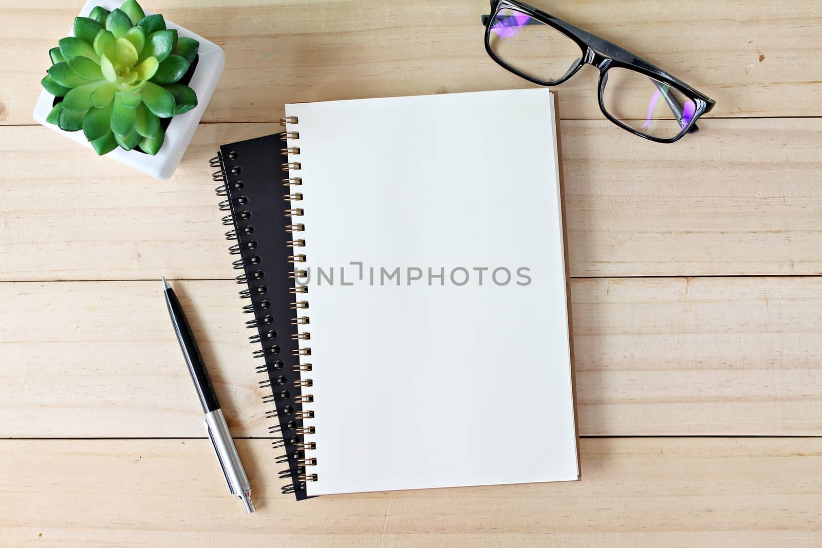 Business, education, still life, working or planning concept : Office desk table with open notebook paper, pen and eyeglasses, Flat lay or top view with copy space, ready for adding or mock up