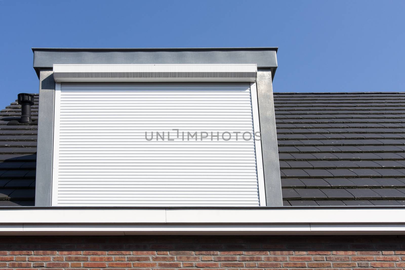 Dormer window with rolling safety  shutter in the Netherlands