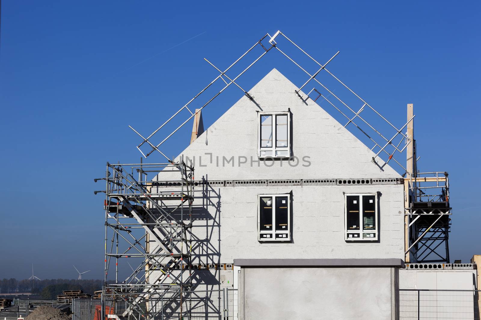 Construction site with houses with prefabricated walls in the Netherlands and a lot of blue sky