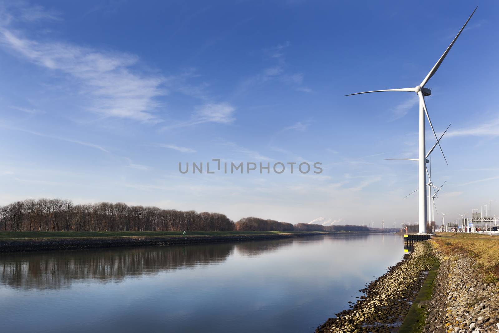 Wind turbines near canal Hartel in industrial area Europoort of Rotterdam in the Netherlands