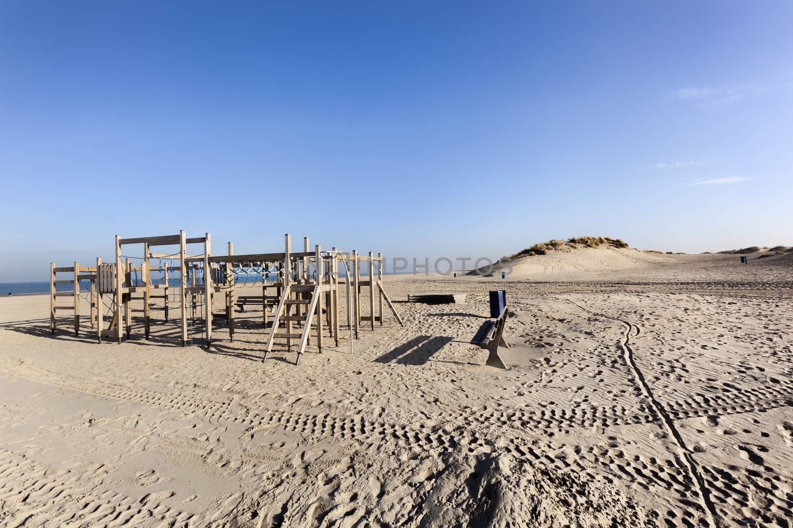 Wooden playground on the beach of Hoek van Holland in the Netherlands with some dunes in the background