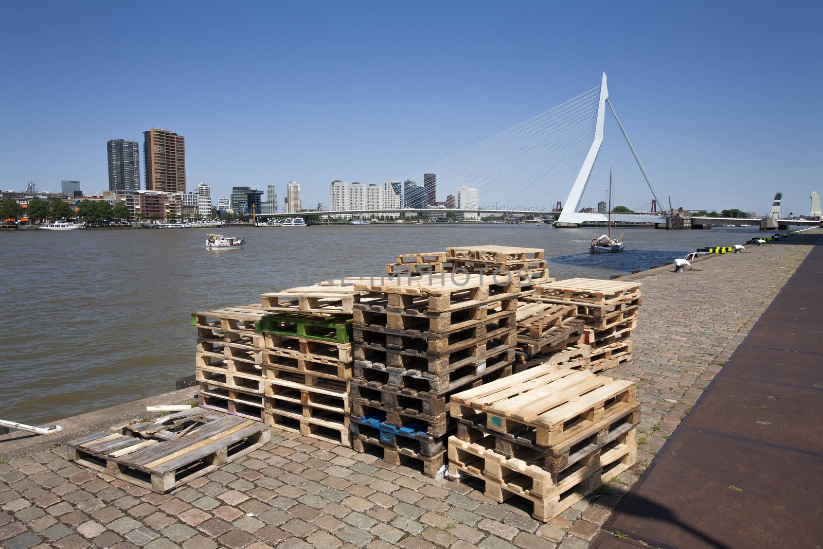 Pallets on the quay side in Rotterdam with the Erasmus bridge in the  background