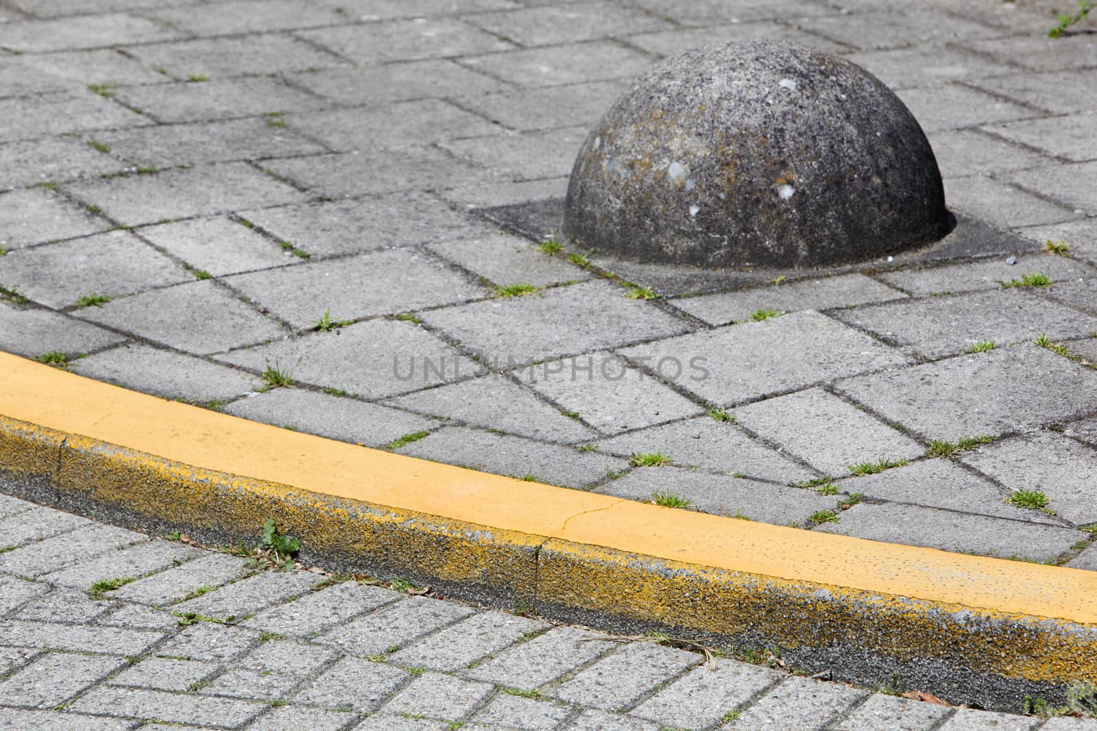 Yellow curb and obstacle on a street corner in the Netherlands