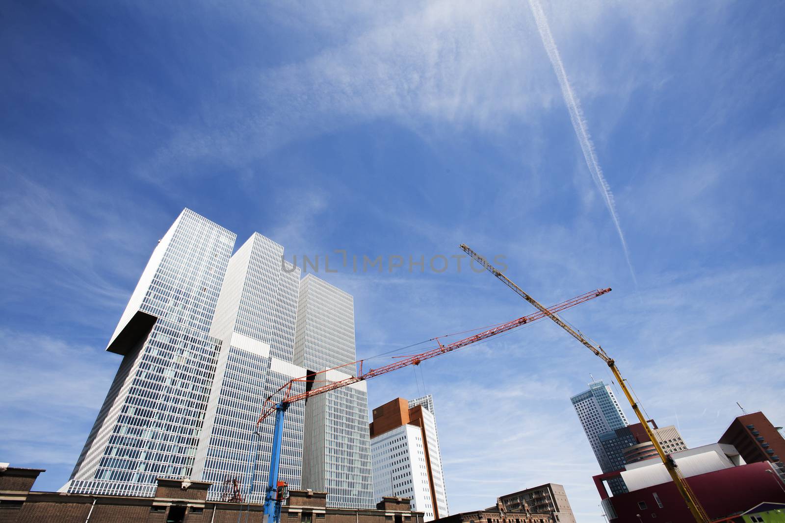 Construction site in Rotterdam, in the Netherlands, with modern architecture and old warehouses in the background