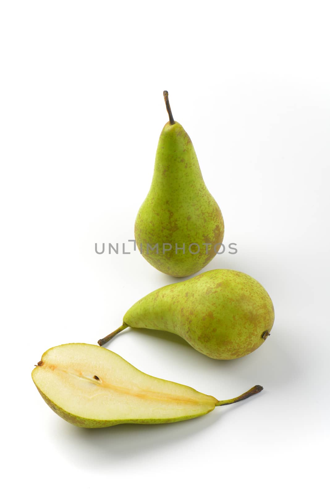two whole fresh green pears and one half